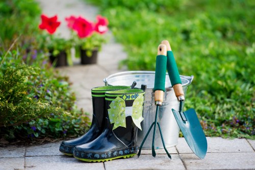 Gardener trimming a formal hedge in an urban garden